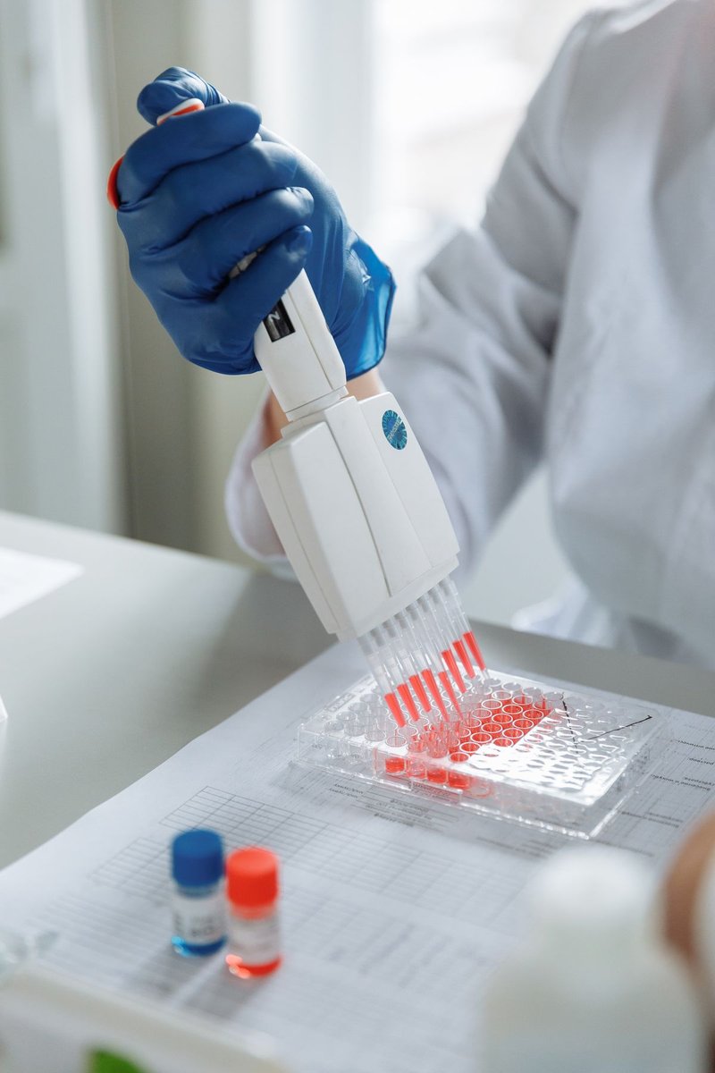 Scientist using a pipette with samples in a laboratory
